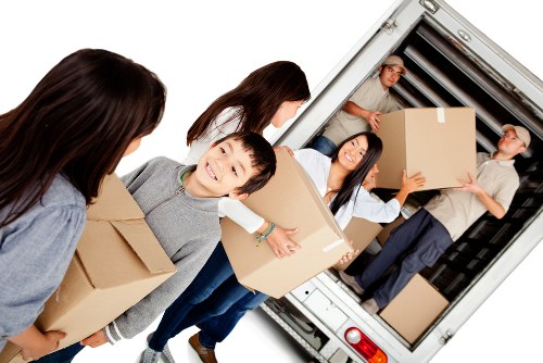 Moving team handling boxes safely outside a property